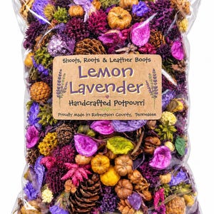 May include: A clear plastic bag filled with colorful potpourri containing dried flowers, pinecones, and small gourds. A tan label reads: Shoots, Roots & Leather Boots, Lemon Lavender, Handcrafted Potpourri, Proudly Made in Robertson County, Tennessee.