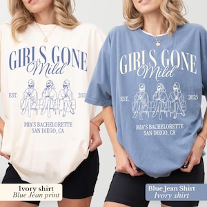 May include: Two oversized t-shirts, one ivory and one blue jean, featuring the text "GIRLS GONE Mild" in a stylized font. The shirts also display a graphic of three figures and the text "MIA'S BACHELORETTE SAN DIEGO, CA" with the years 2021 and 2025.