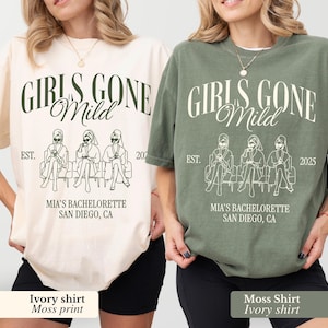 May include: Ivory and moss green t-shirts with the text "GIRLS GONE Mild" and a graphic of three figures. The shirts also read "MIA'S BACHELORETTE SAN DIEGO, CA" and the years 2021 and 2025.