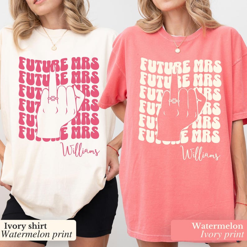 May include: Two t-shirts with a pink graphic of a hand with a ring on the middle finger. The text on the shirts reads "FUTURE MRS" repeated multiple times and "Williams" at the bottom. One shirt is ivory with a watermelon print and the other is watermelon with an ivory print.
