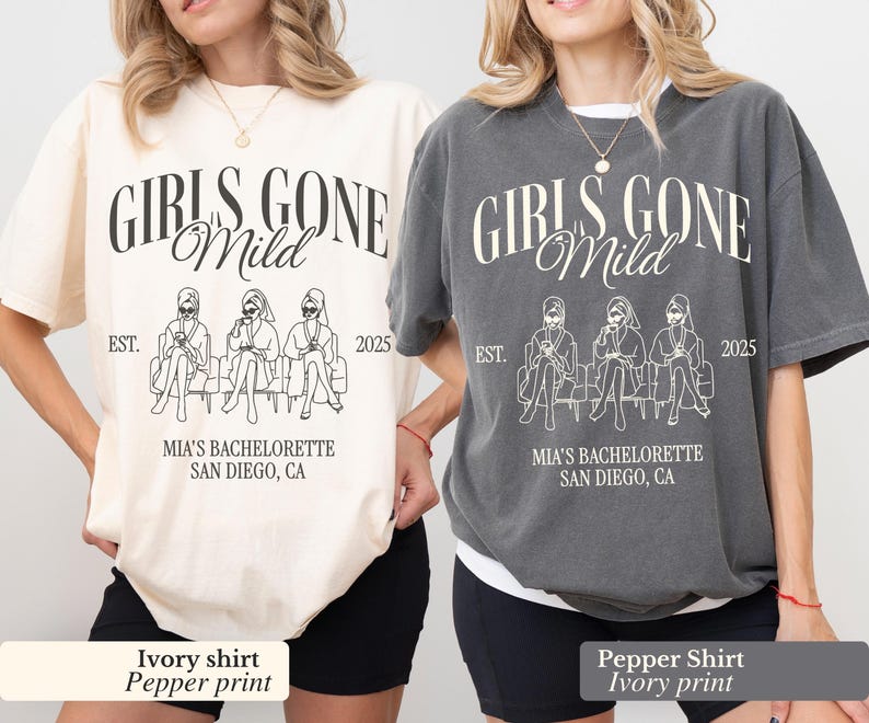 May include: Two t-shirts, one ivory and one pepper, with the text "GIRLS GONE Mild" in a script font. Below the text is a line drawing of three figures seated on a bench. The text "MIA'S BACHELORETTE SAN DIEGO, CA" is below the drawing.