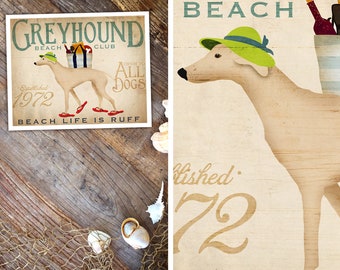 May include: A vintage-style illustration of a Greyhound dog wearing a green hat and red sandals. The dog is standing on a beach with the text "Greyhound Beach Club Established 1972 Open to All Dogs Beach Life is Ruff" in the background.
