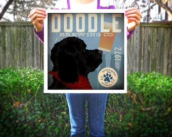 May include: Square print featuring a black dog with a red bandana, drinking beer from a glass. The print has a blue background with the words "DOODLE BREWING CO." and "EST. 1972". A paw print logo is also visible.
