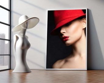 May include: A framed photograph of a woman wearing a red fedora hat. The woman is looking down and her lips are painted red. The background is black.