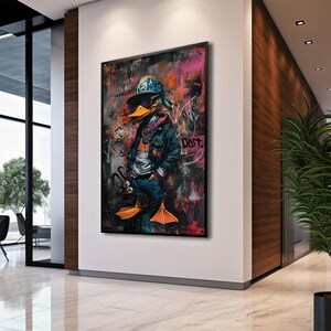 May include: A colorful painting of a duck wearing a blue and white baseball cap, a blue jacket, and jeans. The duck is holding a microphone in its right hand. The background is a graffiti-style design with the word "Dust" written in white.