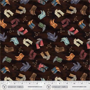 May include: A dark brown fabric featuring a repeating pattern of multi-colored cowboy boots in shades of tan, red, blue, green, and grey, interspersed with small gold horseshoes and stars. A white ruler at the bottom shows 12 inches.