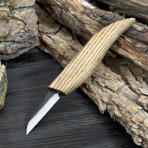May include: A handcrafted knife with a wooden handle and a silver blade. The handle is made of light brown wood with a striped pattern. The blade is a silver color and has a sharp edge. The knife is designed for cutting and slicing.
