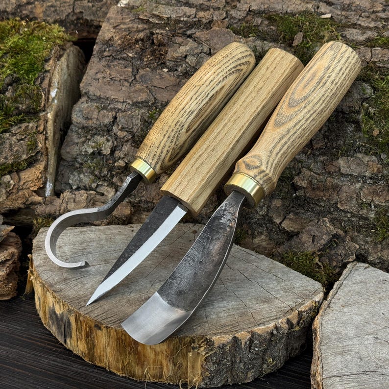 Hand-forged bowl carving tools on wood slice, hook knife and gouge for hollowing work.
