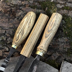 Close-up of ash wood carving tool handles, ergonomic grips for spoon carving tools.