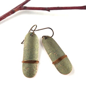 Hand cut, hammered green patina copper earrings.
