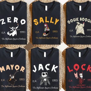 May include: Six black t-shirts featuring characters from The Nightmare Before Christmas. Each shirt displays a character name, the text Est. 1993, and The Nightmare Before Christmas. Characters include Zero, Sally, Oogie Boogie, the Mayor, Jack, and Lock.