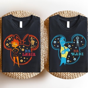 May include: Two black t-shirts with a Mickey Mouse silhouette design. The left shirt features a red and pink bow and a character with orange hair and the text "His Ember". The right shirt features a blue character and the text "Her Wade".