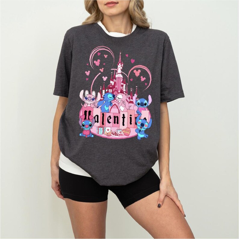 a woman wearing a black shirt with a pink castle on it