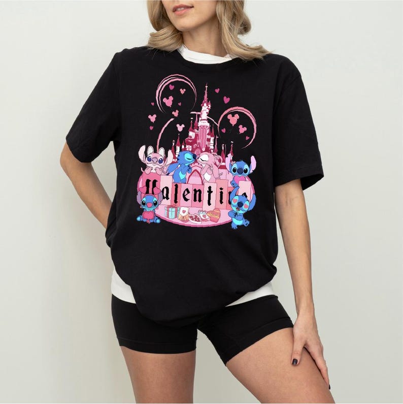 a woman wearing a black shirt with a pink castle on it