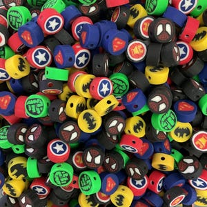 May include: A large assortment of colorful round plastic beads with various superhero logos, including Batman, Superman, Spiderman, and Hulk.