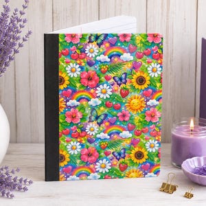 May include: A composition notebook with a black spine and a vibrant, repeating pattern featuring rainbows, butterflies, sunflowers, daisies, hibiscus flowers, cherries, strawberries, hearts, and smiling suns against a bright green background.