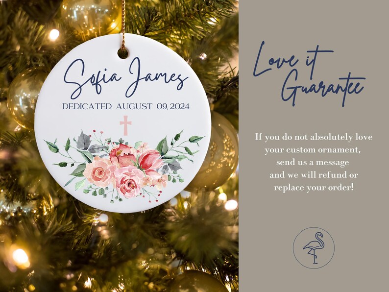 May include: White ceramic Christmas ornament with a pink floral design and a cross. The ornament is personalized with the text "Sofia James Dedicated August 09, 2024".