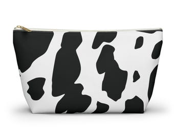 Neceser con estampado de vaca, estuche con cremallera en la parte inferior.