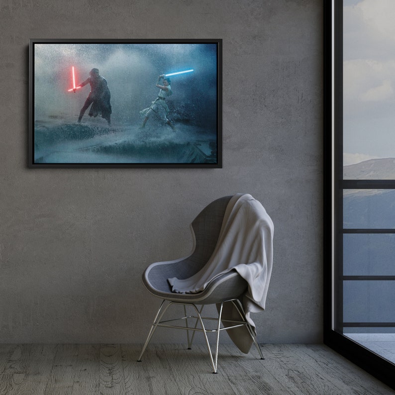 May include: Framed canvas art featuring a Star Wars scene with two figures wielding lightsabers. One figure holds a red lightsaber, the other a blue one. The artwork is set against a stormy, water-filled backdrop, framed in black.