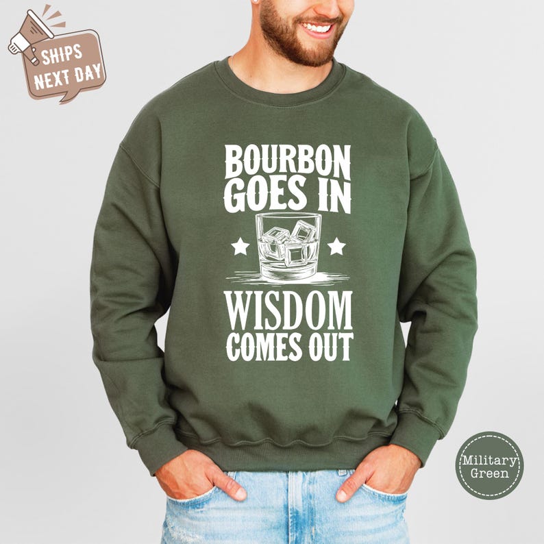 a man wearing a sweatshirt that says bourbon goes in wisdom comes out