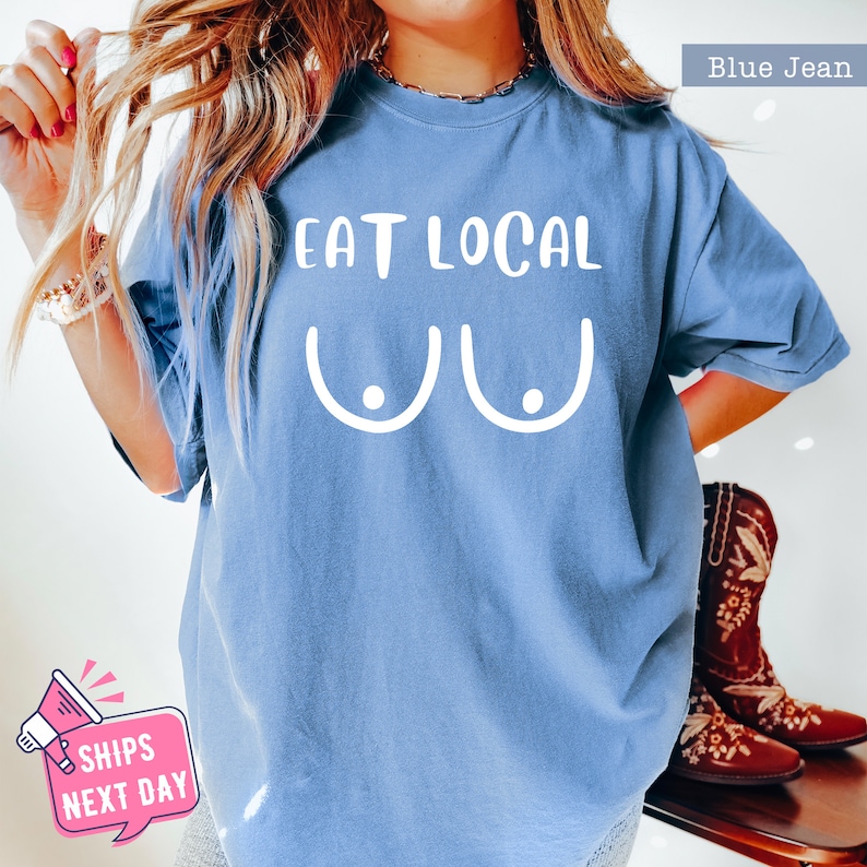 a woman wearing a blue shirt that says eat local