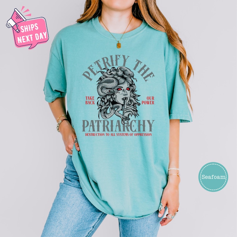 a woman wearing a green shirt with a picture of a woman's face on