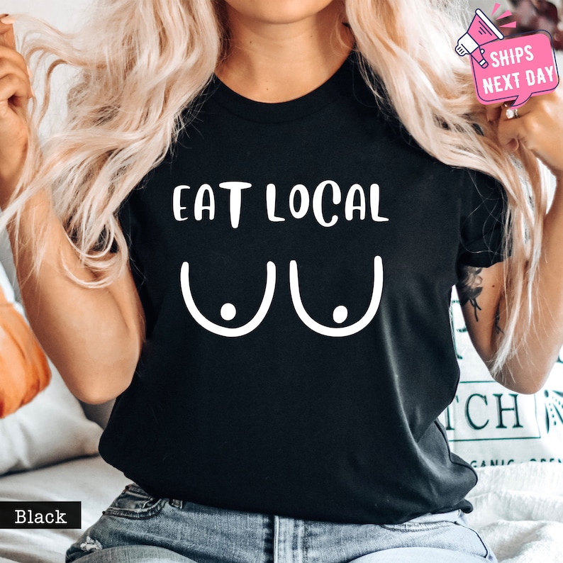a woman wearing a black shirt that says eat local