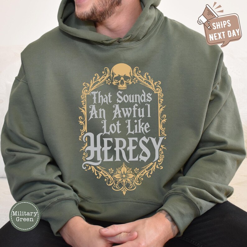a man wearing a green hoodie with a skull on it