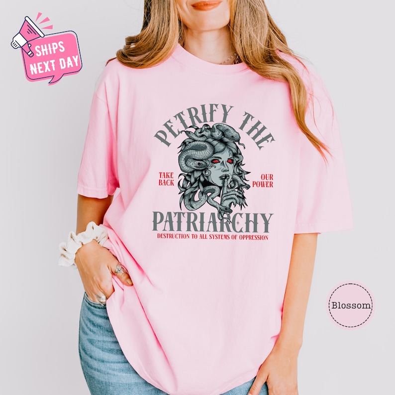 a woman wearing a pink t - shirt with a picture of a woman's