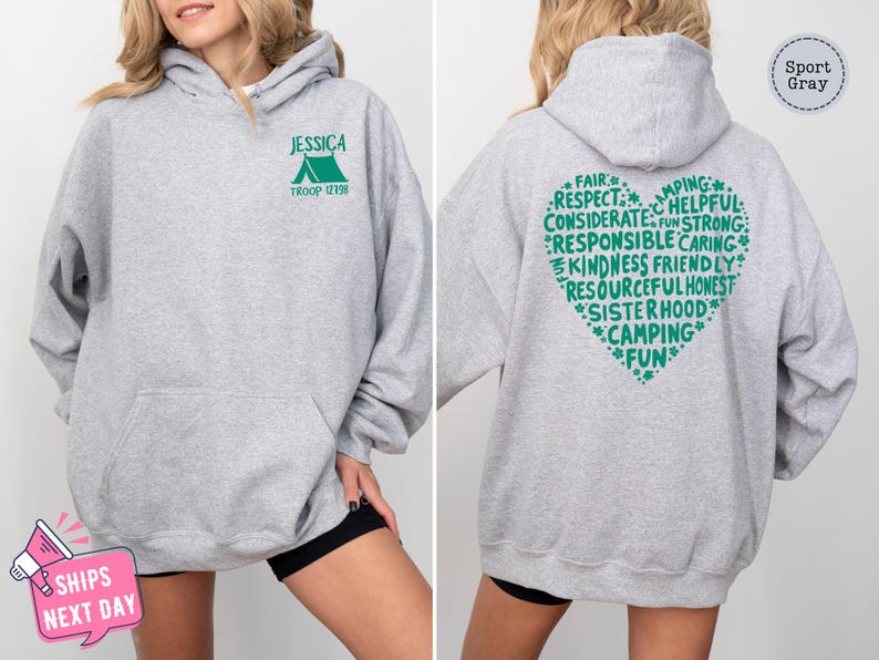 a woman wearing a grey hoodie with green writing on it