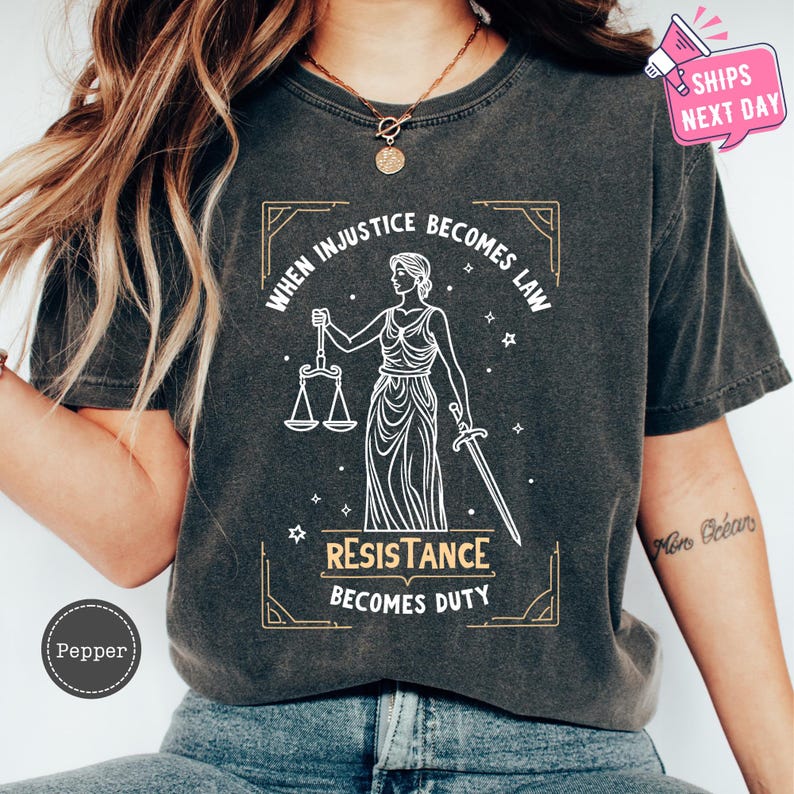 a woman wearing a t - shirt that says, when justice becomes law, resistance