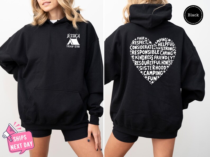 a woman wearing a black hoodie with white writing on it