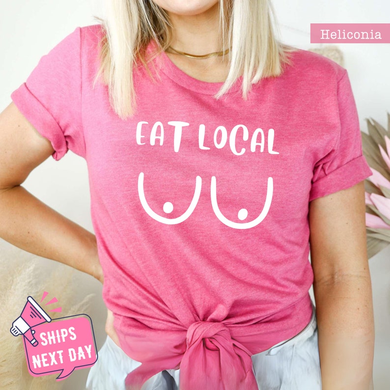 a woman wearing a pink shirt that says eat local