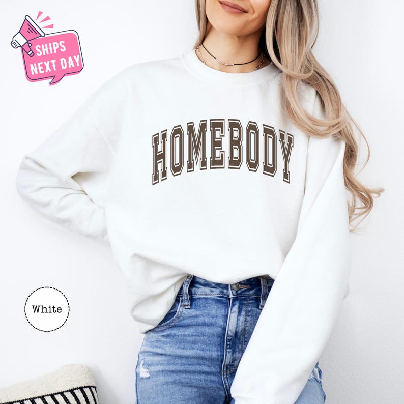 a woman wearing a sweatshirt that says homeboy