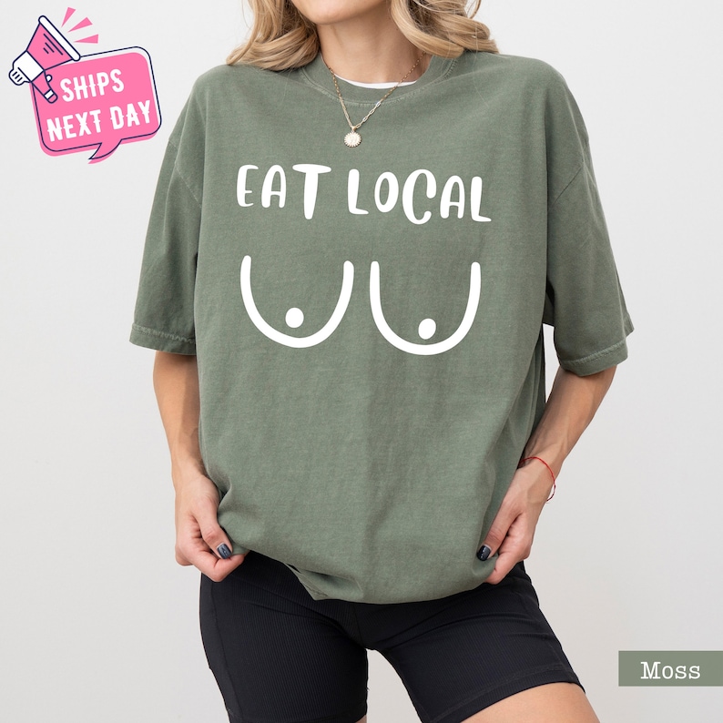 a woman wearing a green shirt that says eat local