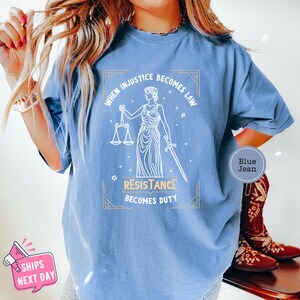 a woman wearing a blue t - shirt that says, when music becomes law,