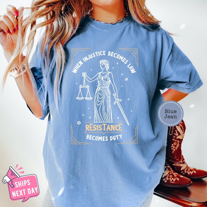 a woman wearing a blue t - shirt that says, when music becomes law,