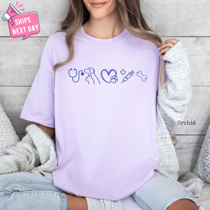 a woman sitting on a bed wearing a purple shirt