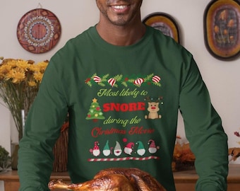 May include: A dark green long-sleeved top with the text "Most likely to snore during the Christmas Movie" and festive graphics. A roasted turkey is presented on a wooden board in the image.