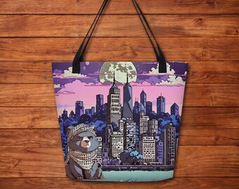May include: A tote bag featuring a graphic illustration of a bear wearing a keffiyeh scarf in front of a stylized city skyline at night. The scene includes a large full moon, purple and pink clouds, and tall buildings under a dark sky.