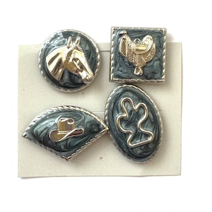 May include: Set of four Western-themed metal buttons. Designs include a horse head, saddle, cowboy hat, and a decorative swirl. Each button has a silver border and a marbled gray and black background.