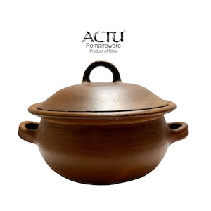May include: A brown clay pot with a matching lid and two side handles. The text ACTU Pomaireware Product of Chile is printed above the pot. The vessel has a rounded body and a smooth, earthy finish, reflecting the natural texture of the clay material.