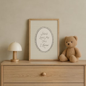 May include: A framed print with the text "Jesus Loves Me This I Know" in an oval. A tan teddy bear and a small wooden lamp sit on a wooden chest of drawers. The print has a light beige gingham background.