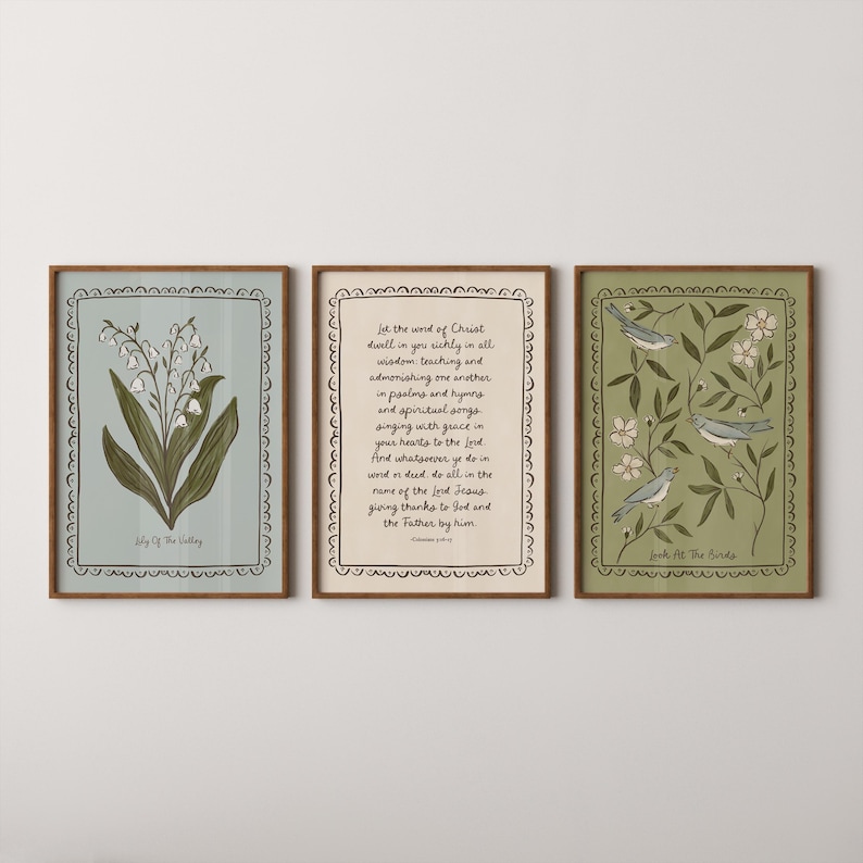 May include: Three framed art prints. The left print features a lily of the valley illustration. The center print has handwritten text. The right print displays birds and floral elements. All prints have decorative borders and are in wooden frames.