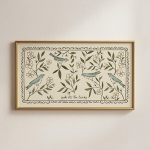 May include: A framed art print featuring four blue birds amidst a floral and foliage design. The artwork includes the text "Look At The Birds" and is set against a cream background, framed in gold.