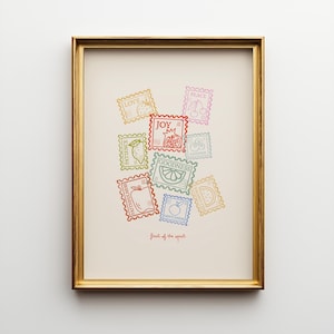 May include: A framed art print featuring colorful postage stamp designs with words like "Love," "Joy," and "Goodness." Each stamp has a fruit illustration. The phrase "fruit of the spirit" is written at the bottom.