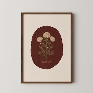 May include: A framed art print featuring a botanical illustration. The artwork showcases three cream-colored flowers with green stems and leaves, set against a dark red oval backdrop. The text "Isaiah 40:8" is at the bottom.