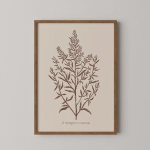 May include: A framed botanical print with a brown illustration of a plant on a beige background. The text "In thy presence is fullness of joy" is at the bottom. The frame is made of brown wood. The print is a decorative item.