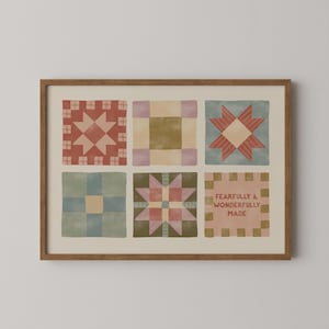 May include: A framed print featuring six colorful quilt block designs. The blocks showcase various patterns in shades of red, blue, green, and pink, with a central star motif in some. The bottom right block has the text "FEARFULLY & WONDERFULLY MADE".