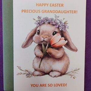 May include: Happy Easter Precious Granddaughter! card with a cute bunny wearing a flower crown and holding a pink tulip. The card has a white background with orange text.